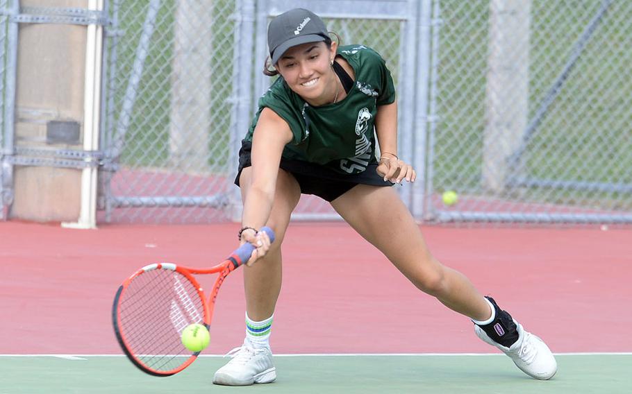 Kubasaki's Lan Legros lunges for the ball during Tuesday's Okinawa's doubles tennis matches. Legros teamed with Isabella Suber to win her girls doubles match, then with Jacy Fisk to win her mixed doubles match.