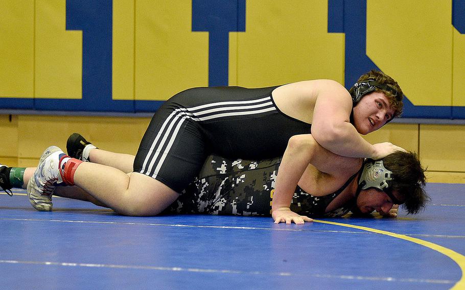 Spangdahlem's Eli Hulet keeps Stuttgart's Cyrus Montandon against the ground during the 285-pound title-bout at the Warrior Wraggle on Jan. 13, 2024, at Wiesbaden High School in Wiesbaden, Germany.