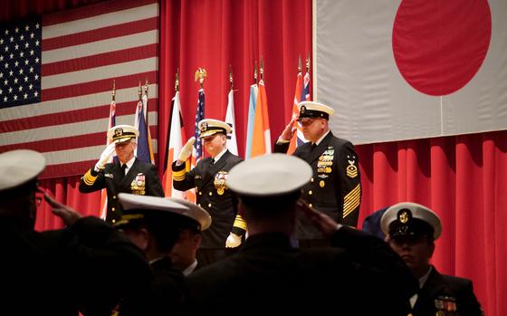 Outgoing 7th Fleet commander Vice Adm. Karl Thomas, left, incoming commander Vice Adm. Fred Kacher and Command Master Chief Petty Officer Daniel Field salute during a change of command ceremony at Yokosuka Naval Base, Japan, Feb. 15, 2024.