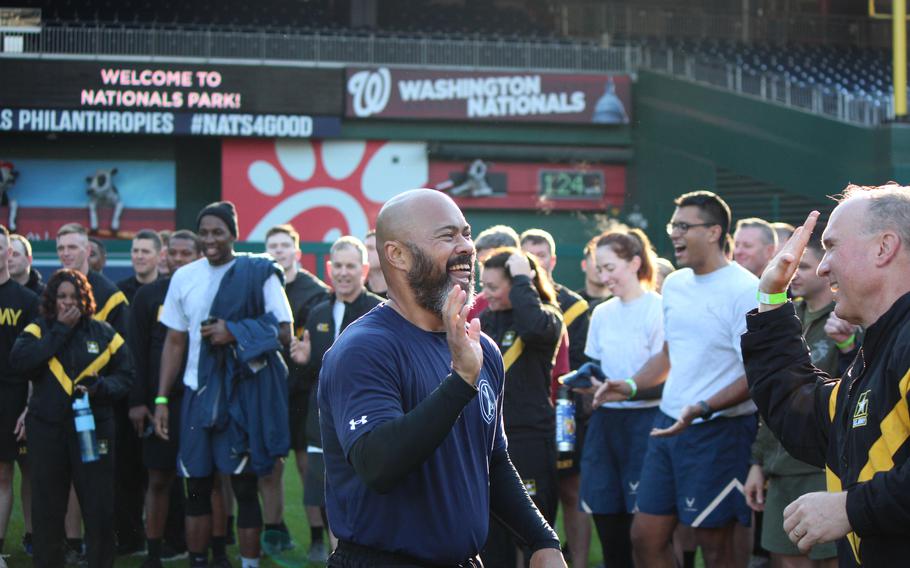 Bart Jumaoas, center, is all smiles despite being eliminated from the final competition of the day, the Wheel of Death, during a Base HIIT physical training session on Oct. 24, 2023, at Nationals Park in Washington, D.C. Base HIIT (high intensity interval training) is just one way the Washington Nationals build ties with the military as part of their Nats on Base program.