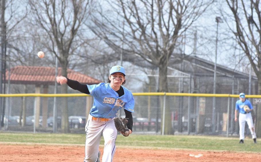 Sigonella's Keivon Cayton throws the ball toward the plate Saturday, March 18, 2023, during a game against the Aviano Saints.