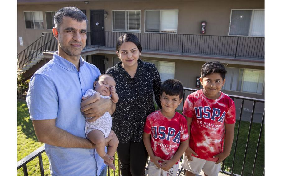 Hamid and Masooda Qazi, shown with their kids Dewa, 2 months old, Hasib, 6, and Habib, 10, at their San Diego apartment on Sept. 22, 2022. 