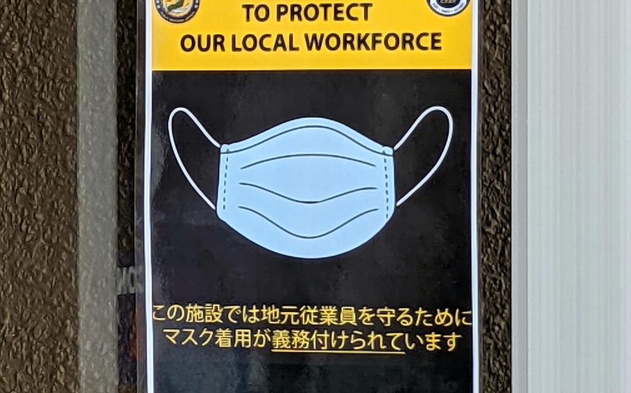 A sign warns customers to wear masks at a Navy Exchange on Yokosuka Naval Base, Japan, Friday, May 28, 2021. 