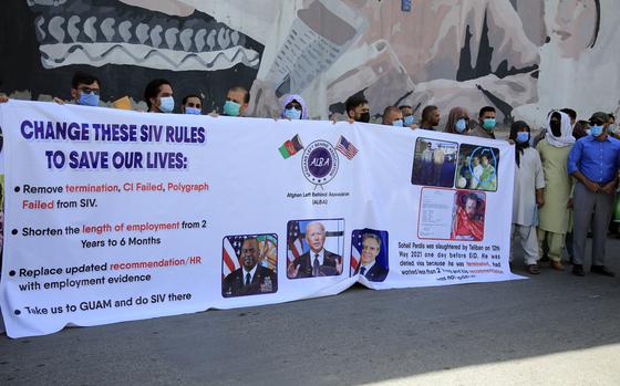 In this June 25, 2021 photo, former Afghan interpreters hold placards during a demonstrations against the US government, in front of the US Embassy in Kabul, Afghanistan.  The Biden administration says it will evacuate about 2,500 Afghans who worked for the U.S. government and their families to a military base in Virginia pending approval of their visas. The administration notified Congress on Monday that the Afghans will be housed at the Fort Lee Army base south of Richmond starting next week.  (AP Photo/Mariam Zuhaib)