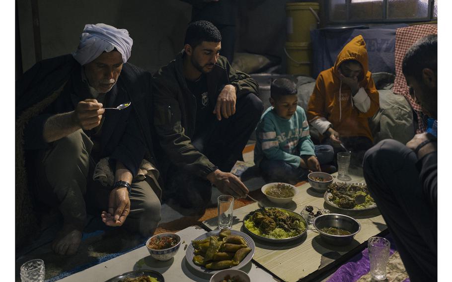 Samamreh, far left, eats an iftar meal with his children.