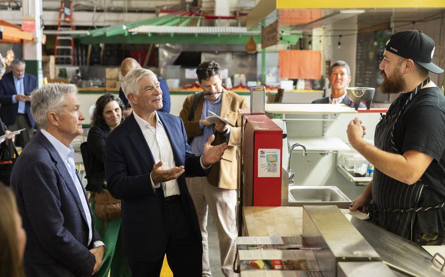 Fed Chair Jerome Powell and Philadelphia Fed President Patrick Harker during a walking tour in the Central Market in York, Pa.