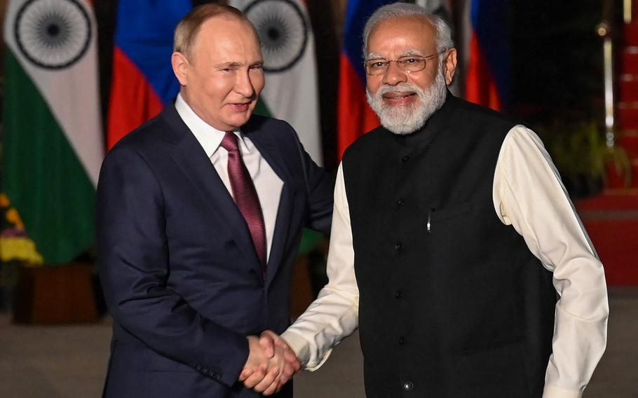 India's Prime Minister Narendra Modi, right, greets Russian President Vladimir Putin before a meeting at Hyderabad House in New Delhi on Dec 6, 2021.