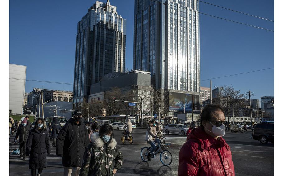 Pedestrians on the street of Chaoyang district in Beijing, China, on Dec. 30, 2022. 