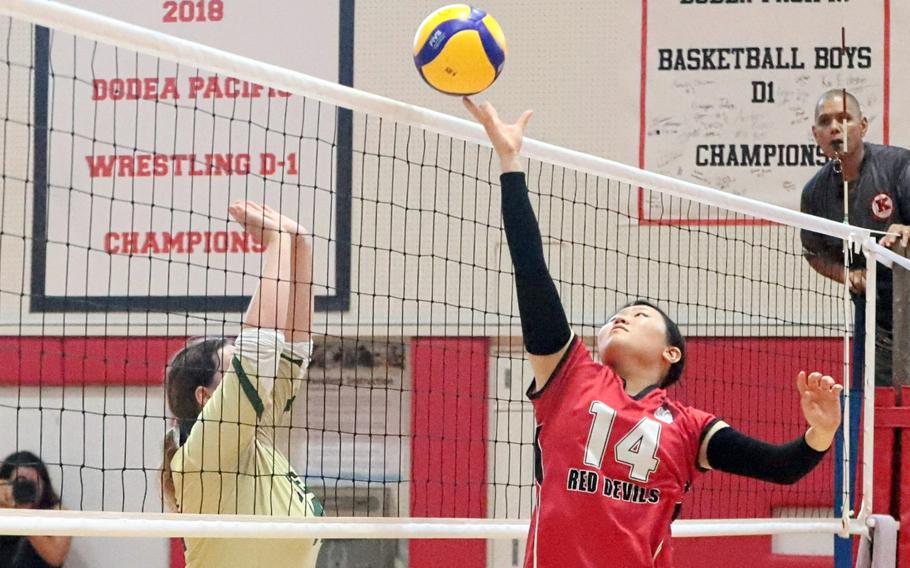 Kay Kim taps the ball over the net.