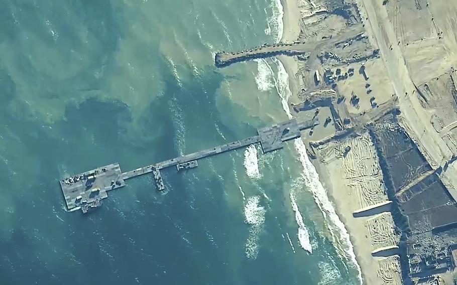 The image provided by U.S, Central Command, shows U.S. Army soldiers assigned to the 7th Transportation Brigade (Expeditionary), U.S. Navy sailors assigned to Amphibious Construction Battalion 1, and Israel Defense Forces placing the Trident Pier on the coast of Gaza Strip on May 16, 2024.
