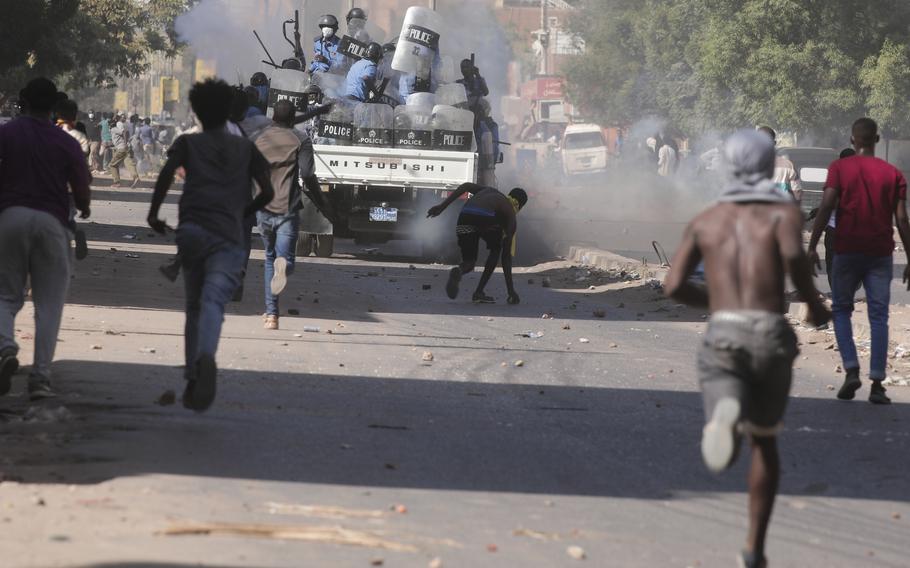 Sudanese confront the police during a protest against the military coup that ousted government last month, in Khartoum, Sudan, Wednesday, Nov. 17, 2021.