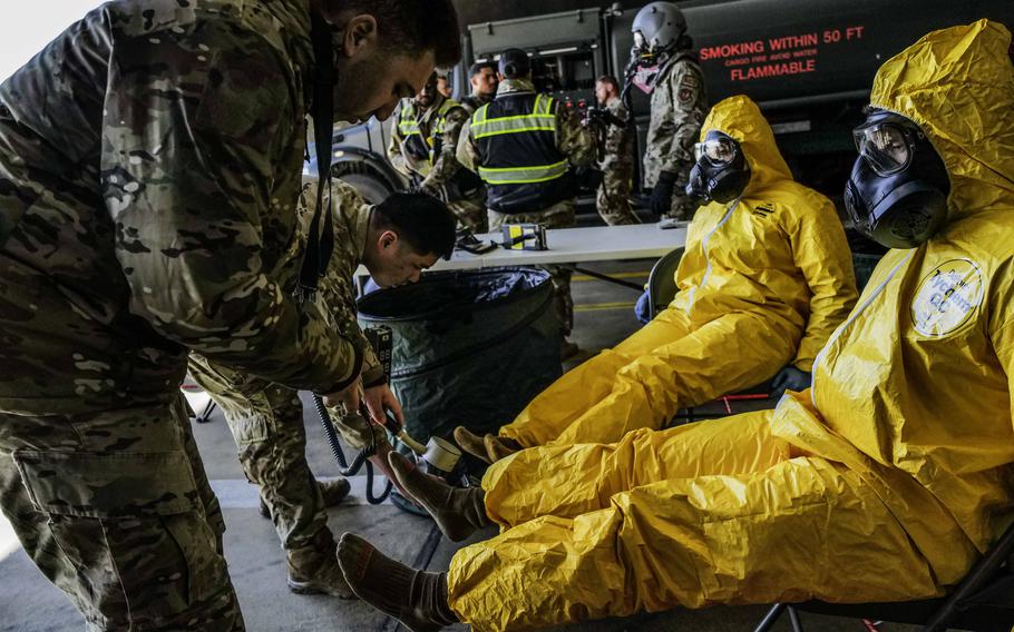 Staff Sgt. Christopher Richardson, left, and Airman 1st Class Jason Trinh check F-16 maintainers for radiation exposure during exercise Radiant Falcon April 24, 2024, at Spangdahlem Air Base, Germany. Richardson and Trinh are emergency management technicians with the 52nd Civil Engineer Squadron.