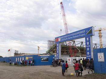 Construction workers, some accompanied by relatives, wait to get paid at the $50 million stadium that China is building in Honiara ahead of the 2023 Pacific Games. 