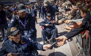 U.S. veterans parade during a gathering in preparation of the 79th D-Day anniversary in Sainte-Mere-Eglise, Normandy, France, Sunday, June 4, 2023. The landings on the coast of Normandy 79 year ago by U.S. and British troops took place on June 6, 1944. 