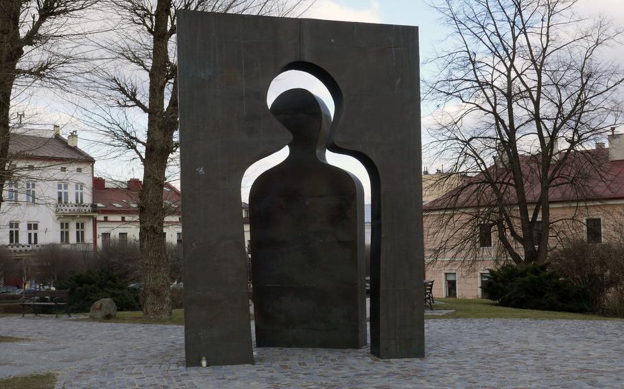 In the center of Rzeszow, Polands Cichociemnych Square is this interesting sculpture by local artist Jozef Szajna called "Przejscie 2001" or Transition 2001. The square is named for the elite World War II exiled Polish army special operations paratroopers, trained in Great Britain to operate in occupied Poland. Circling the monument are plaques with the names of people deported to Auschwitz. 