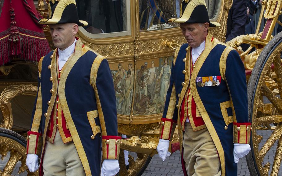 Footmen walk alongside the Golden Carriage as it arrives at Noordeinde Palace in The Hague, Netherlands, on Sept. 17, 2013. Netherlands’ King Willem-Alexander on Thursday, Jan. 13, 2022, ruled out using the carriage in the near future due to controversy surrounding the colonial past it represents.