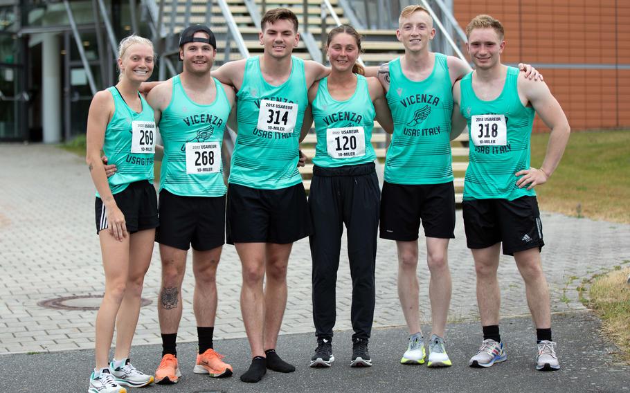 Samantha Hengehold, left, and Eva Perry, center, pose with teammates Reed Schaaf, Jamie Knott, Brayden Naylor and Peter Lafond after completing the Army Ten-Miler qualifier run in Grafenwoehr, Germany, on June 25, 2022. Perry and Hengehold finished first and second, respectively, out of a field of 18 women in the race.
