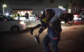 A man hauls another person on his back.