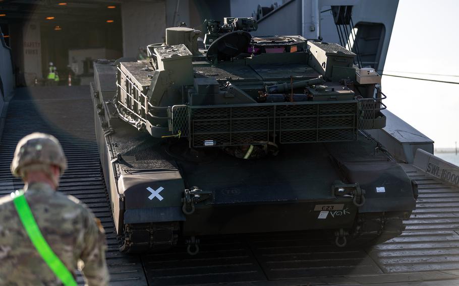 A U.S. soldier guides an M1A2 Abrams tank off the USNS Bob Hope at the Port of Gladstone in Queensland, Australia, July 15, 2023.