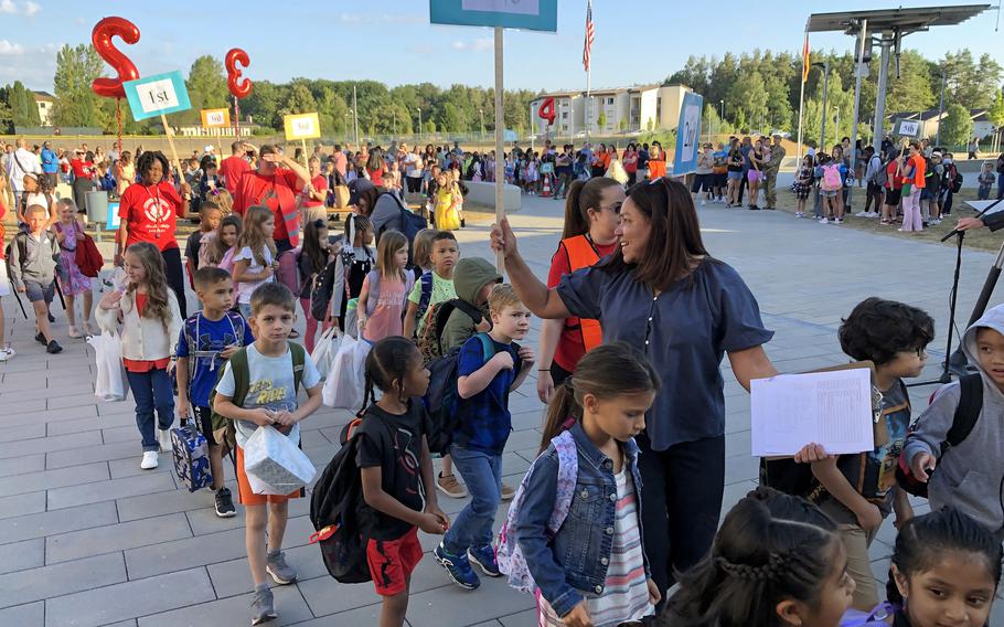 Students walk with their new classmates and teachers on the first day of school at Kaiserslautern Elementary School in Kaiserslautern, Germany, Aug. 22, 2022.