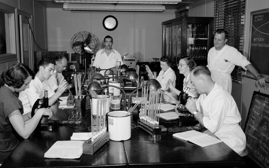 Lab workers conduct research in the venereal disease laboratory at the Centers for Disease Control and Prevention’s Chamblee campus in Georgia in 1950.
