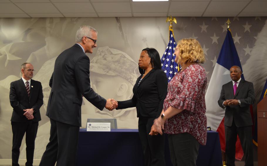 Department of Veterans Affairs Secretary Denis McDonough shakes hands with Shanda Richardson, one of the first people hired Thursday, Feb. 9, 2023, at a hiring fair at the Waco VA Regional Office in Texas. Richardson, an Army Reserve veteran and VA employee, will now train for a new job rating benefit claims with the Veterans Benefits Administration.