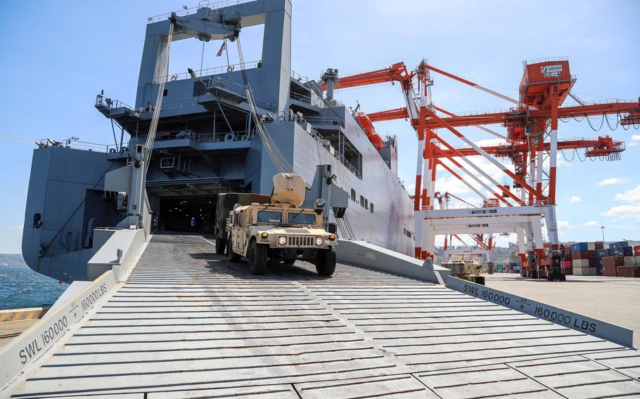 Military vehicles from the 402nd Army Field Support Battalion are downloaded from the USNS Red Cloud at Subic Bay, Philippines, Feb. 24, 2022.