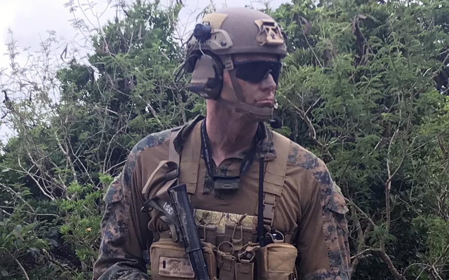 A member of the 3rd Battalion, 4th Marine Regiment waits to board a CH-53 Super Stallion helicopter at Camp Schwab, Okinawa, Feb. 14, 2023, during jungle warfare training.