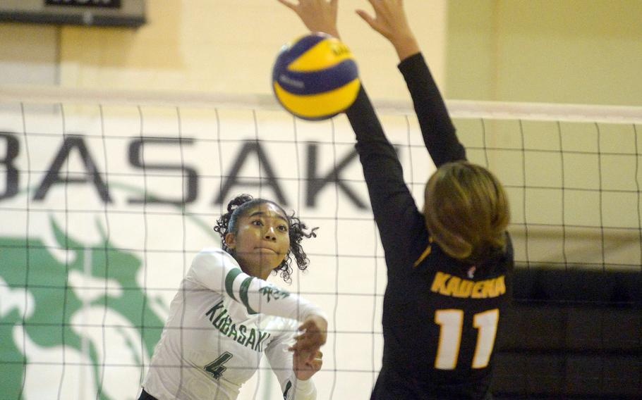 Kubasaki’s Risha McGriff spikes past Kadena’s Presley Pearce during Thursday’s Okinawa volleyball match. 