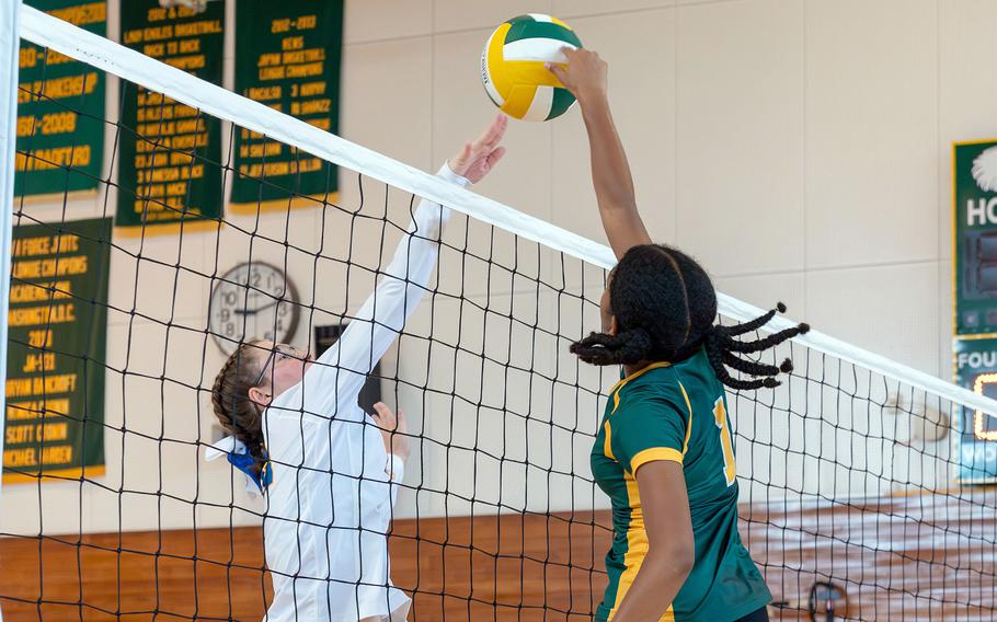 Robert D. Edgren's Nia Tyler and Yokota's Kayla Bogdan battle for the ball during Saturday's Japan volleyball match. The Panthers won in four set.