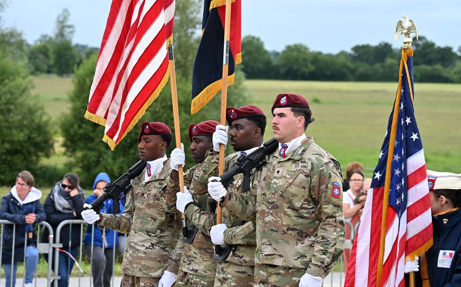 Honor Guard soldiers carry flags.