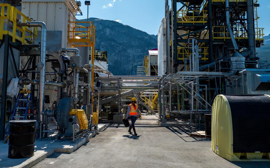 A worker walks through the Carbon Engineering Innovation Centre, a direct air capture research and development facility May 26, 2023, in Squamish, British Columbia. Provisions in the Inflation Reduction Act could allow emerging technologies to curb carbon emissions significantly after 2030.