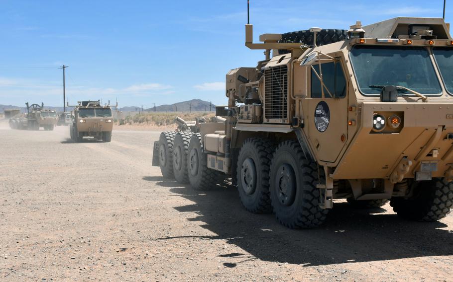 Semi-autonomous vehicles drive past attendees during a ceremony at Fort Bliss, Texas, in April 2019. The Army's new Task Force 39 wants to bring the trucks to the Middle East for testing.