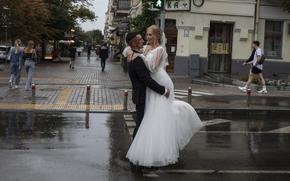 A bride and groom on a rainy day before their wedding in Kyiv, Ukraine, on July 24, 2022. 