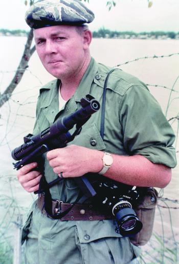 Joseph L. Galloway is seen with Swedish K submachine gun and Nikon F camera in August 1965.
