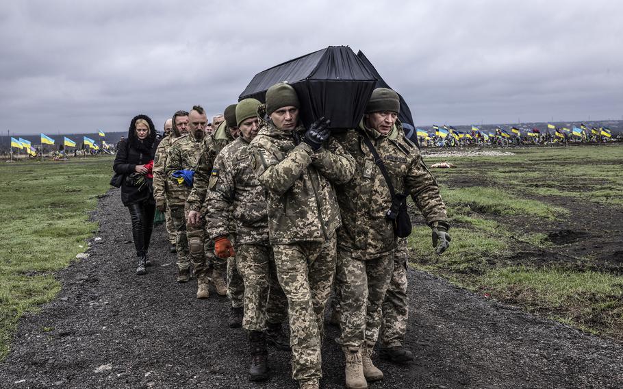 Ukrainian soldiers carry the coffin of Vlad, 26, during his funeral at the military cemetery in Dnipro last week. 