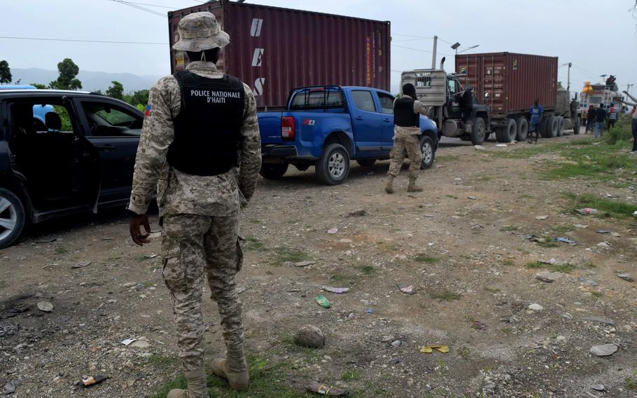 Haitian National Police provide protection to an aid convoy offering earthquake relief in southern Haiti. 