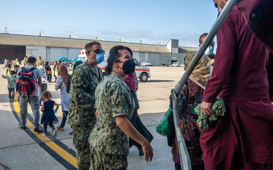 Sailors welcome evacuees from Afghanistan arriving at Naval Station Rota, Spain, on Friday, Aug. 27, 2021.