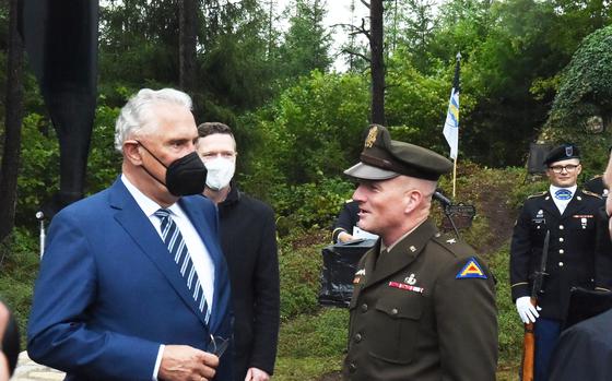Bavaria's Interior Minister, Joachim Herrmann, left, speaks with Brig. Gen. Joseph Hilbert, commander of the 7th Army Training Command, right, during the 50th anniversary ceremony for the Pegnitz helicopter crash on Aug. 18, 2021, near Pegnitz, Germany.