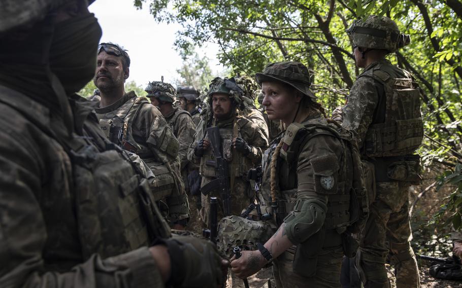 Elenna, 24, a female member of Ukraine’s Territorial Defense forces together with the other troops as they stopped on a road that leads to Lysychansk, Ukraine on June 21, 2022. 