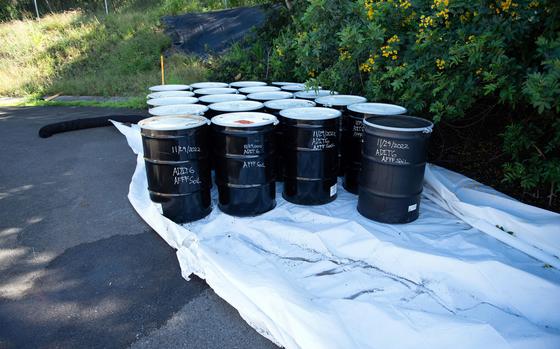 Drums for contaminated soil stand at the temporary staging area used for cleanup of toxic firefighting foam at the Red Hill fuel storage facility on the outskirts of Honolulu, Hawaii, Wednesday, Nov. 30, 2022.