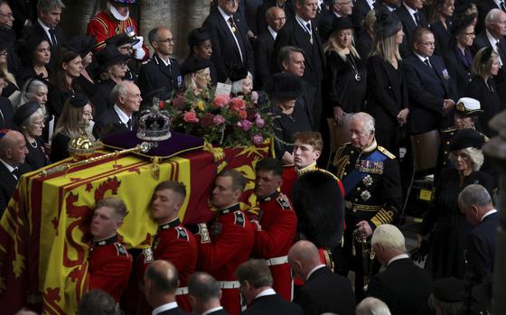 Britain's Queen Elizabeth's coffin is carried as King Charles III, Camilla, the Queen Consort and Princess Anne follow, during the funeral in London, Monday Sept. 19, 2022. 