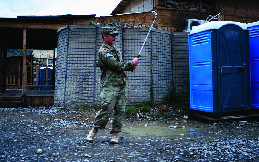 Sgt. Gregory Leatherman works on his swing at Combat Outpost Sabari shortly before going on leave. He plans to play with friends and family back home.