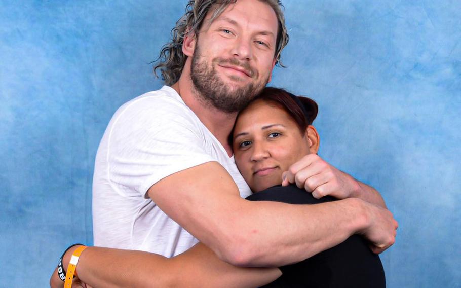 Maj. Issa Alvarez, a manpower, personnel and services support deputy with 5th Air Force at Yokota Air Base in Tokyo, poses with her favorite wrestler, Kenny Omega. 