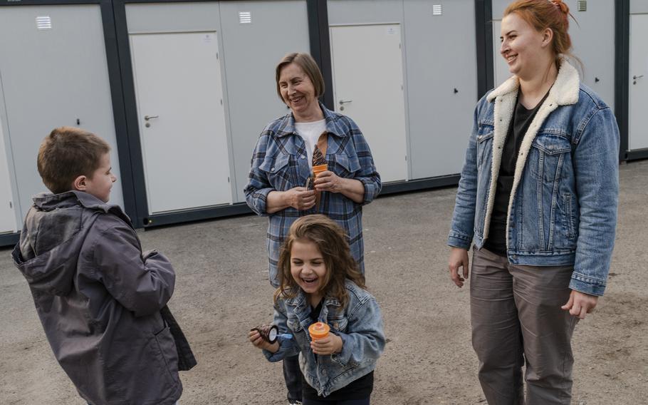 Liubov Makarenko, center back, escaped with her daughter and her daughter's son, Giorgi, 10, left, from Mariupol in March. She was joined in Lviv by her other daughter Oleksanda Koriuk, right, and her granddaughter Sofia, 5, who escaped from Kharkiv. They now live in a modular housing unit in Stryiskyi Park. 