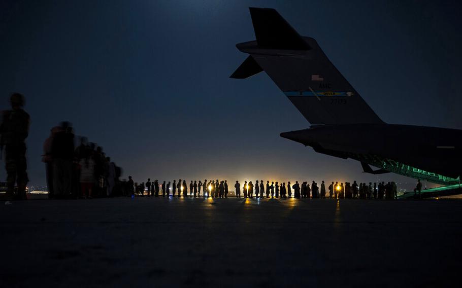 In this Aug. 21, 2021, file image provided by the U.S. Air Force, U.S. Air Force aircrew, assigned to the 816th Expeditionary Airlift Squadron, prepare to load qualified evacuees aboard a U.S. Air Force C-17 Globemaster III aircraft in support of the Afghanistan evacuation at Hamid Karzai International Airport, Kabul, Afghanistan. 
