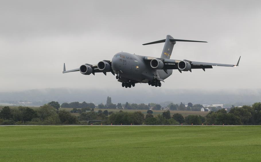 An Air Force C-17 transport plane lands at Wiesbaden Army Airfield in Germany on Sept. 1, 2023, carrying two AH-64E Apache Guardian helicopters for the 12th Combat Aviation Brigade.
