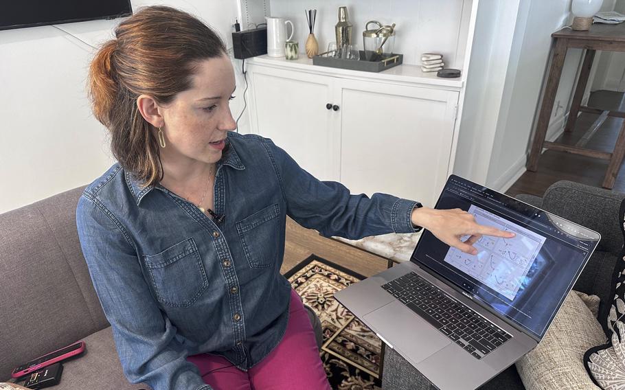 A linguist points to a diagram on her computer screen. 