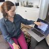 A linguist points to a diagram on her computer screen. 