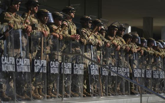 California National Guard members, with their shields, are positioned at the Federal Building in downtown Los Angeles, on June 10, 2025. 